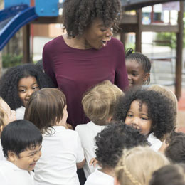 Teacher surrounded by children