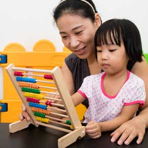 Parent playing with child on an abacus
